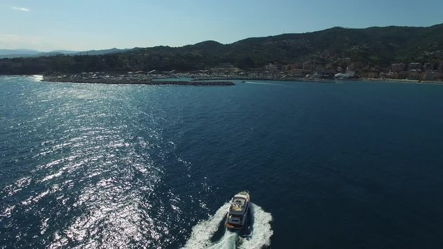 Aerial view yacht cruising into the port of Varazze, Italy.