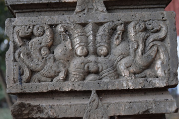 ancient ruined stone carving of Hindu god in the old city of India