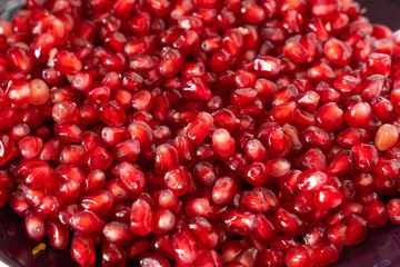 red ripe pomegranate seeds on a plate close-up. pomegranate fruit. healthy diet