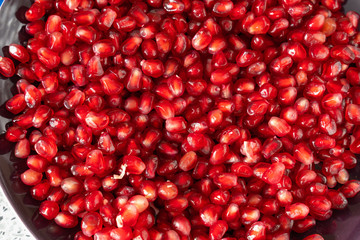 red ripe pomegranate seeds closeup. health food. beautiful background texture of pomegranate fruit seeds