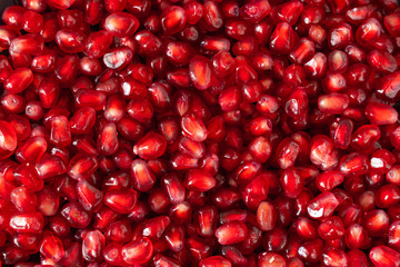 red ripe pomegranate seeds closeup. health food. beautiful background texture of pomegranate fruit seeds