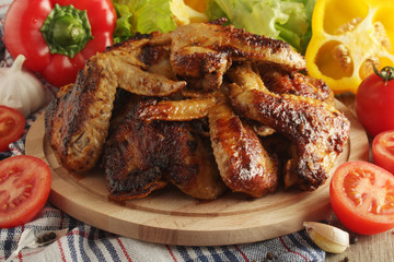 Chicken wings barbecue with different vegetables	