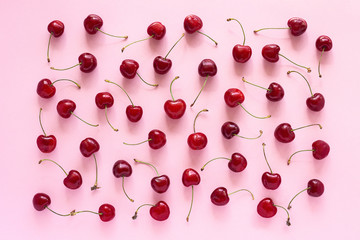 Red ripe sweet cherry on pink background, texture or background.