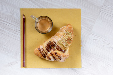 Stuffed brioche and coffee on a wooden table