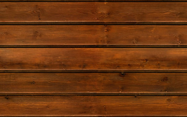 Fototapeta premium Wooden brown grain texture, dark wall background, top view of wooden table. Seamless texture