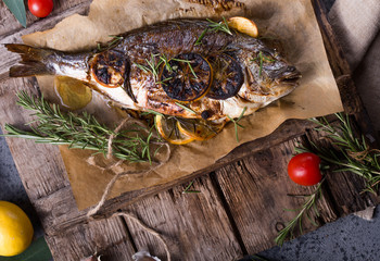 Fresh Grilled Dorado with Lemon and Cherry Tomatoes. Whole Bbq Sea Bream Fish Top View and Flat...