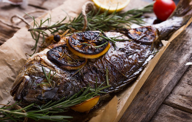 Fresh Grilled Dorado with Lemon and Cherry Tomatoes. Whole Bbq Sea Bream Fish Top View and Flat Lay. Sparus Aurata Close Up for Restaurant Menu or Recipe Illustration