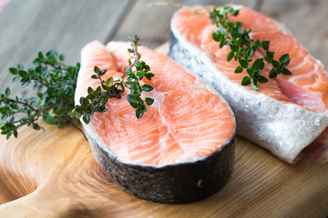 Salmon fish. Uncooked salmon fillet with ingredients for cooking - fresh lemon and spices on Wooden. Top view with copy space.