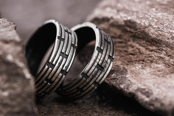 Silver mens rings on the stones, close-up
