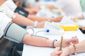 Doctor checking patient arterial blood pressure in hospital. Health care Concept