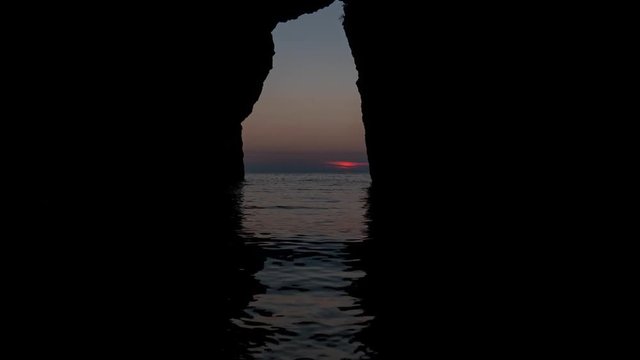 San Nicola Arcella, Cosenza, Calabria, Italy - September 6 2018: time lapse sunset in Arcomagno (Arco magno), beautiful Italian beach and natural arch on Mediterranean sea (Tyrrhenian)