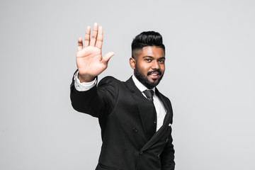 Indian Businessman gestures STOP with his hand, isolated on white background