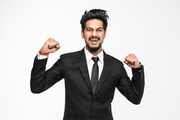 Portrait of a indian young business man enjoying success, screaming against white background