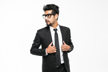 Happy handsome young indian businessman standing confidently isolated on white background
