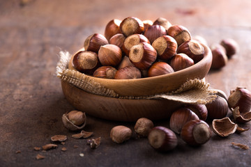Hazelnuts and hazelnut shell on the wooden table.