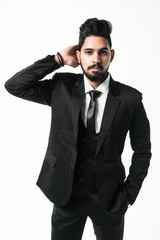 Portrait of handsome confident businessman in jacket touching his hair isolated on white