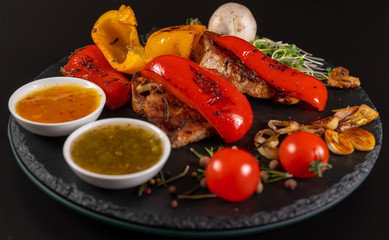 Roast red sweet peppers served with pork