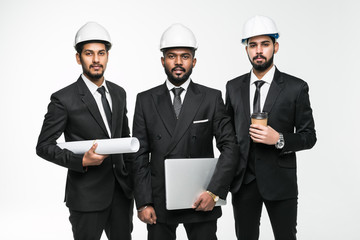 Architects next project. Three indian businessmen architect in the construction helmets standing isolated on white background