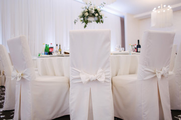 Decoration of tables in restaurant for wedding. Beautiful white decor inside