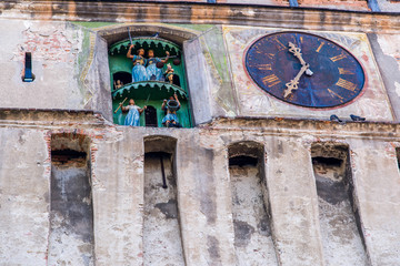 Functional medieval clock on the tower with moving hand carved wood dolls.