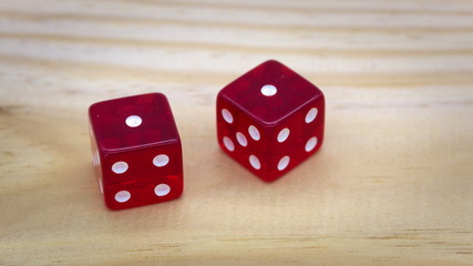 Red dice isolated on a wood background, doublets 1
