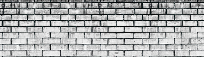 Obraz premium Wide old white shabby brick wall texture. Light gray aged masonry panorama. Whitewashed brickwork panoramic grunge background