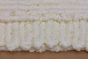 Texture and background of the wall of construction foam laid on a cardboard