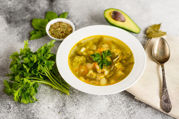 Tasty vegetables and spices soup on a gray concrete background. It can be used as a background