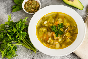 Tasty vegetables and spices soup on a gray concrete background. It can be used as a background