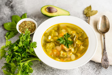 Tasty vegetables and spices soup on a gray concrete background. It can be used as a background