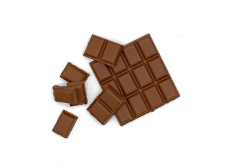 Milk chocolate bar and chocolate pieces isolated on white background