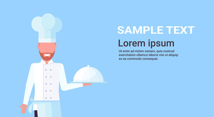 chef cook holding covered platter with dish man in uniform professional occupation food cooking concept male cartoon character portrait blue background horizontal copy space