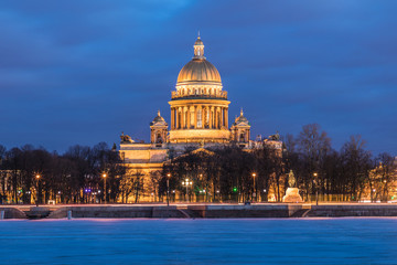 Fototapeta na wymiar Neva river under the ice and snow and Beautiful Saint Isaac's Cathedral or Isaakievskiy Sobor in Saint Petersburg, Russia