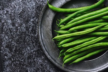 Green beans on the dark background isolated