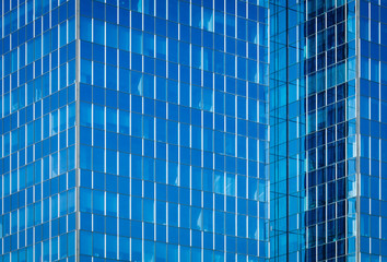 Glass of modern tower for business background, blue tone