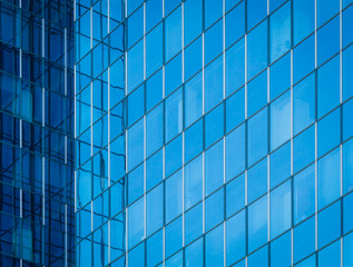 Glass of modern tower for business background, blue tone
