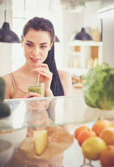 Smiling woman taking a fresh fruit out of the fridge, healthy food concept