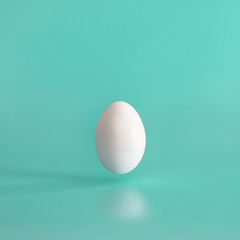 White egg on a blue uniform background.