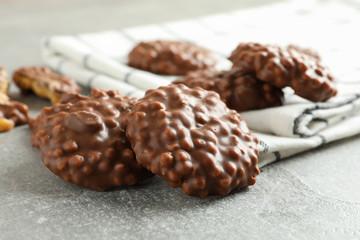 Chocolate cookies and kitchen towel on grey table, closeup
