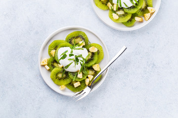 Kiwi salad with caramelized bananas. mint leaves and fresh yohgurt