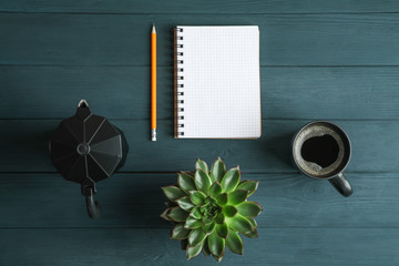 Flat lay composition with cup of coffee, copybook, pencil and succulent plant, space for text