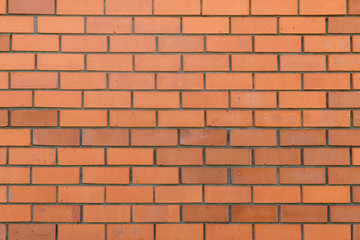 brick wall of rows of red ceramic bricks