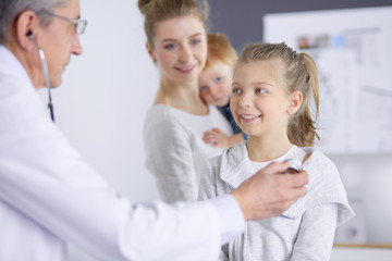 Little children with her mother at a doctor on consultation