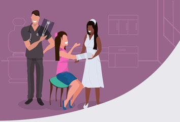 male doctor traumatologist examining x-ray anfrican american nurse bandaging injured patient with broken hand medical treatment healthcare concept horizontal