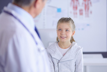 Portrait of a cute little girl and her doctor at hospital