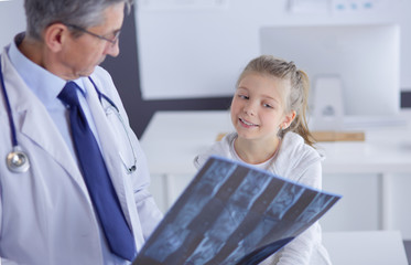 Fototapeta premium Portrait of a cute little girl and her doctor at hospital