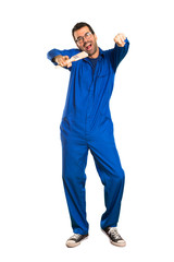 A full-length shot of a Painter man points finger at you while smiling on isolated white background