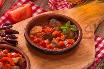Marinated pork loin in tomato sauce.