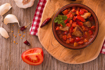 Marinated pork loin in tomato sauce.