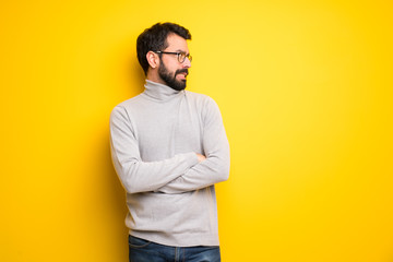 Man with beard and turtleneck is a little bit nervous and scared pressing the teeth